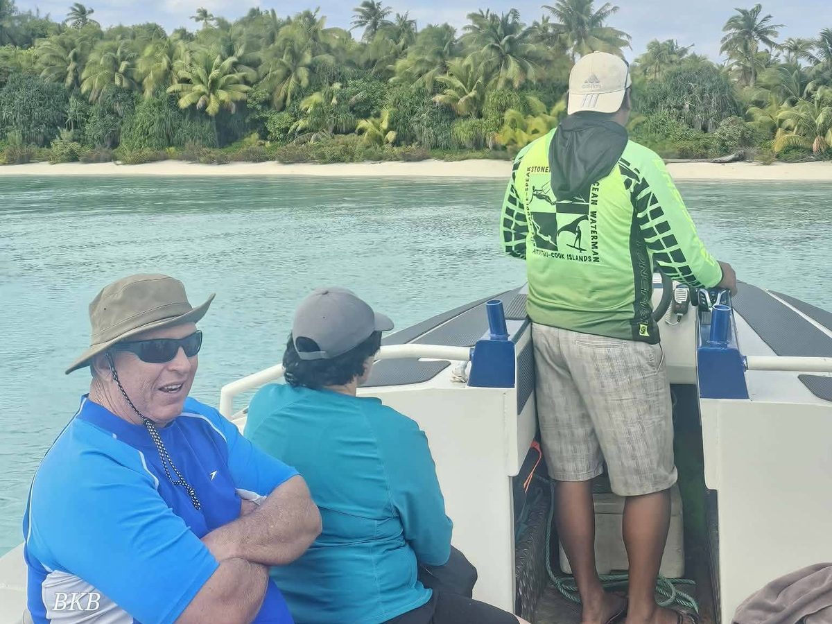 Our skipper at the wheel taking guests across the lagoon towards a motu